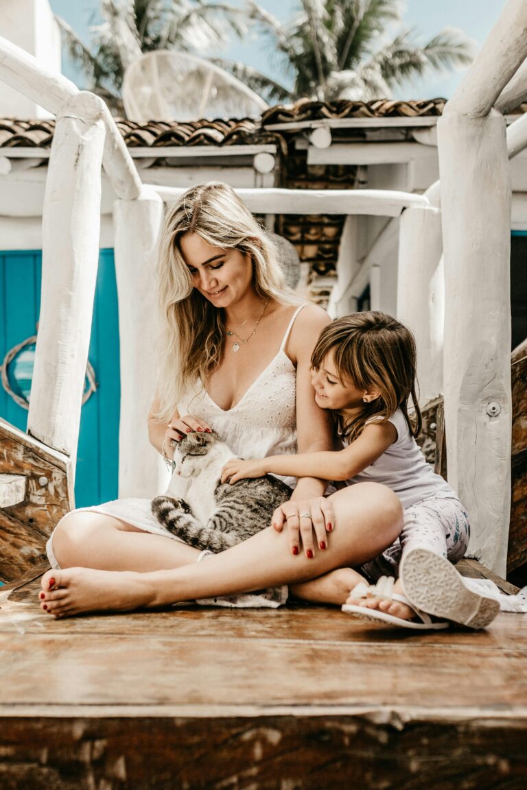 Woman and her Child Sitting while Holding a Cat